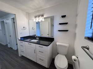 Bathroom featuring vanity, dark wood-style floors, and a textured ceiling
