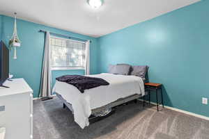 Bedroom featuring carpet floors and a textured ceiling
