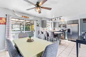 Dining room featuring light tile patterned floors, a textured ceiling, and ceiling fan