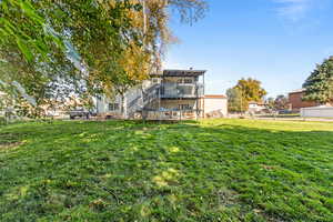 Rear view of house featuring stairway