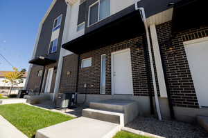 View of exterior entry featuring brick siding