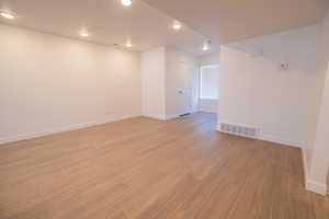 Spare room featuring light wood-style floors and recessed lighting