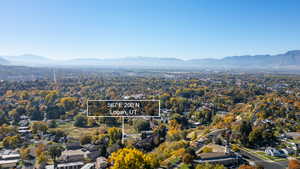 Aerial view of residential area featuring mountains and property boundaries highlighted