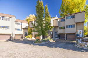 View of building exterior featuring a residential view and a garage