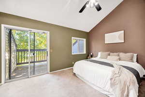 Carpeted bedroom featuring access to outside, a ceiling fan, and high vaulted ceiling
