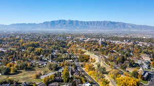 Aerial view of residential area featuring a mountain backdrop and property boundaries highlighted