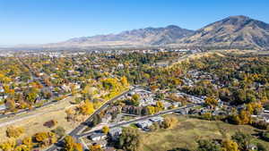 Aerial overview of property's location with mountains and nearby suburban area