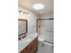 Bathroom with vanity, a shower stall, and light tile patterned floors
