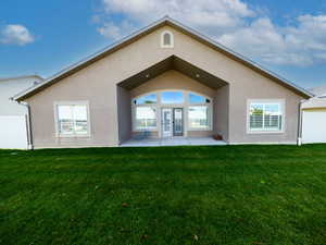 Rear view of house with stucco siding and a patio
