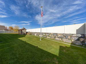 Fenced backyard with a storage shed