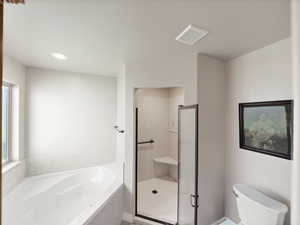 Full bath with a bath, a shower stall, and recessed lighting