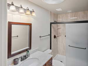 Full bath with vanity and a stall shower
