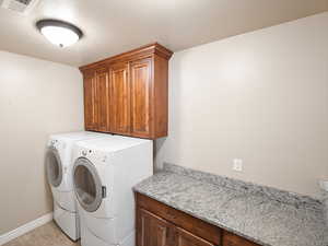 Laundry room with cabinet space and separate washer and dryer