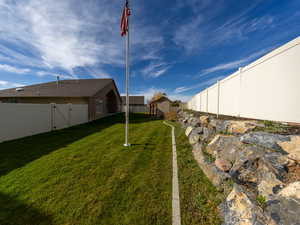 Fenced backyard with a storage shed