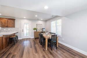 Dining room featuring dark wood finished floors, recessed lighting, and a textured ceiling