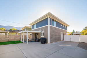 Back of house with a patio, a gate, a pergola, and a mountain view