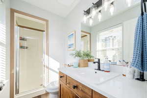 Bathroom featuring a shower stall and vanity
