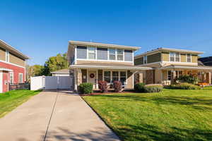 View of front of property with a gate, a porch, and concrete driveway