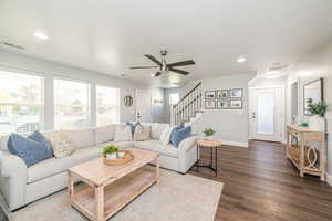 Living room featuring dark wood finished floors, recessed lighting, stairway, and a ceiling fan