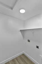 Washroom with light wood-style flooring, electric dryer hookup, and hookup for a washing machine