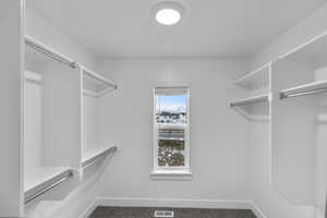 Spacious closet with carpet flooring