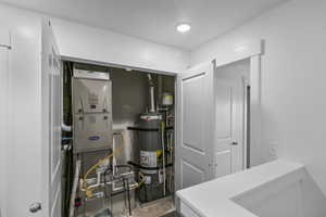 Utilities featuring heating unit and strapped water heater