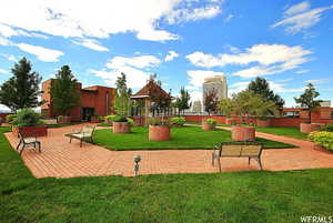 View of home's community with a lawn and a patio area