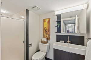 Bathroom with a shower stall and vanity