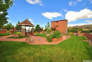 Surrounding community featuring a gazebo, a patio, a wooden deck, and a vegetable garden