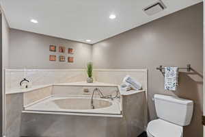 Full bath with a garden tub and recessed lighting