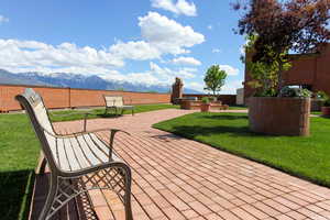 Wooden terrace featuring a mountain view and a fenced backyard