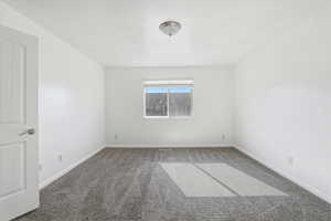 Carpeted empty room with baseboards