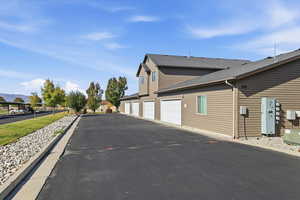 View of side of property with a shingled roof