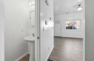 Corridor featuring baseboards and light wood-type flooring