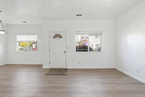 Foyer with plenty of natural light and light wood finished floors