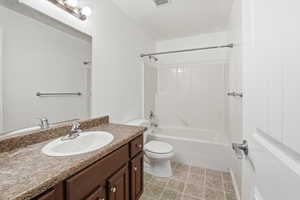 Full bathroom with vanity, shower / bathtub combination, and light tile patterned flooring
