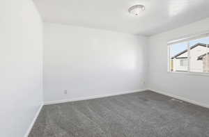 Carpeted empty room with baseboards