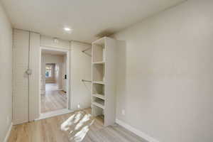 Walk in closet featuring light wood-type flooring