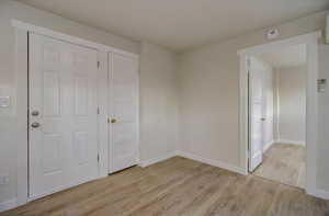 Spare room with light wood-style flooring and a smoke detector
