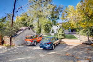 View of vehicle parking featuring view of scattered trees