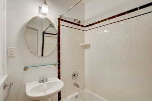 Bathroom featuring shower / bath combination and a sink
