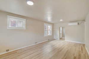 Unfurnished room featuring baseboards and light wood finished floors