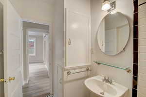Bathroom featuring a sink and wood finished floors
