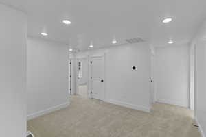 Unfurnished room with light carpet and recessed lighting