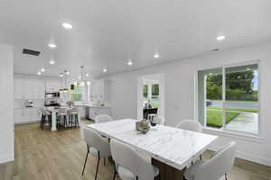 Dining room featuring light wood-style floors and recessed lighting