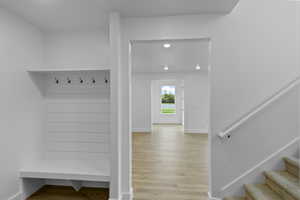 Mudroom with light wood-type flooring and recessed lighting