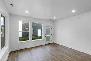 Empty room featuring wood finished floors and recessed lighting