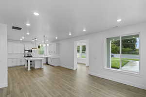 Unfurnished living room featuring light wood-type flooring and recessed lighting