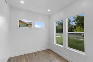 Empty room featuring light wood-style floors and recessed lighting