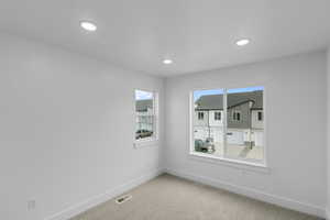 Empty room featuring carpet flooring and recessed lighting